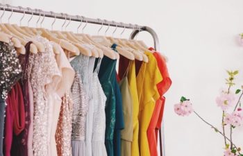 A clothing rack with various colorful dresses