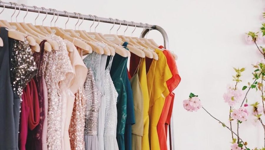 A clothing rack with various colorful dresses