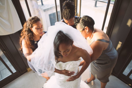 A bride is helped by her ladies