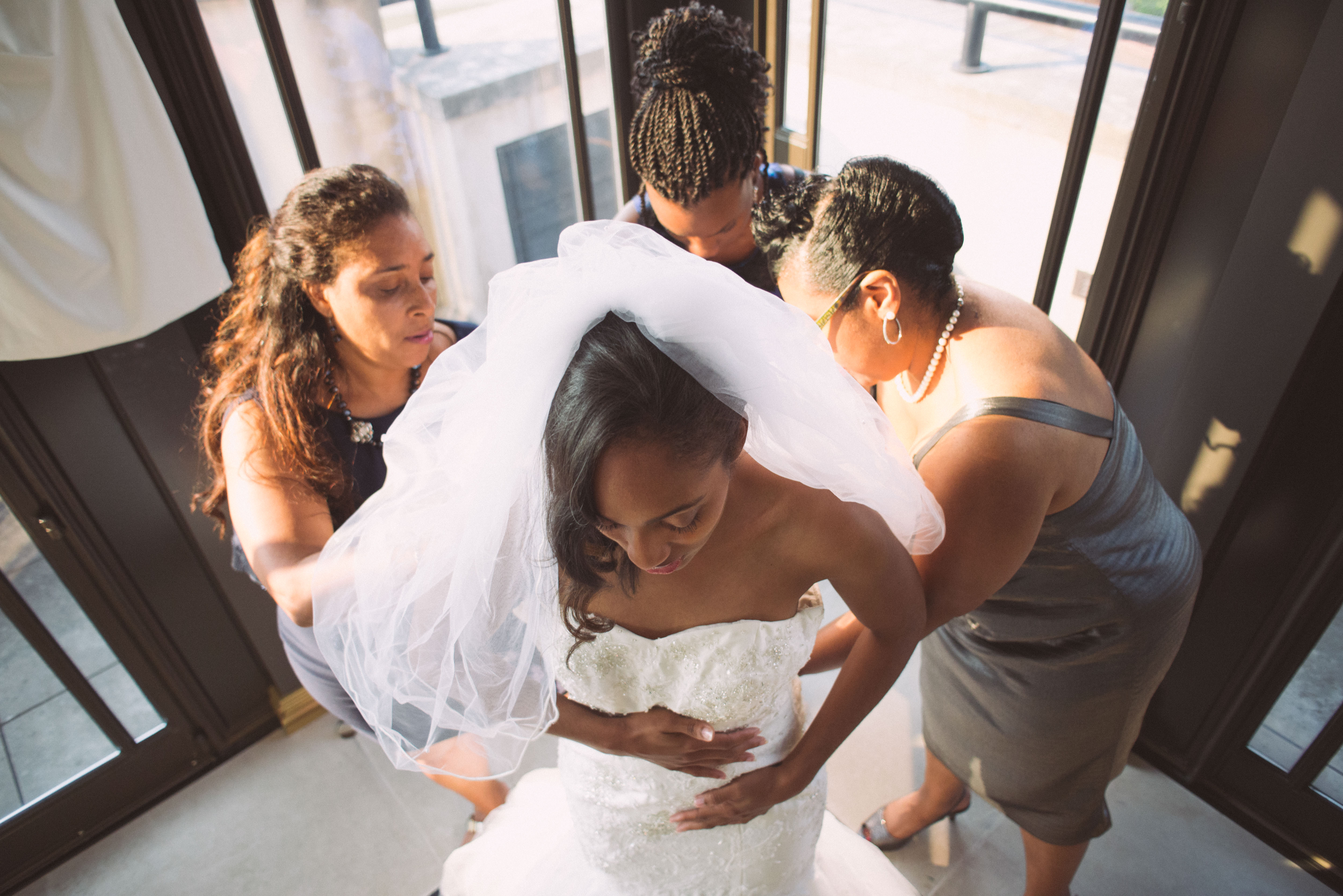 A bride is helped by her ladies
