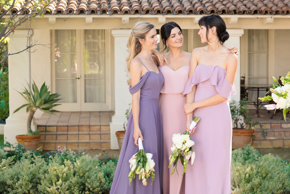 Three bridesmaids stand together 