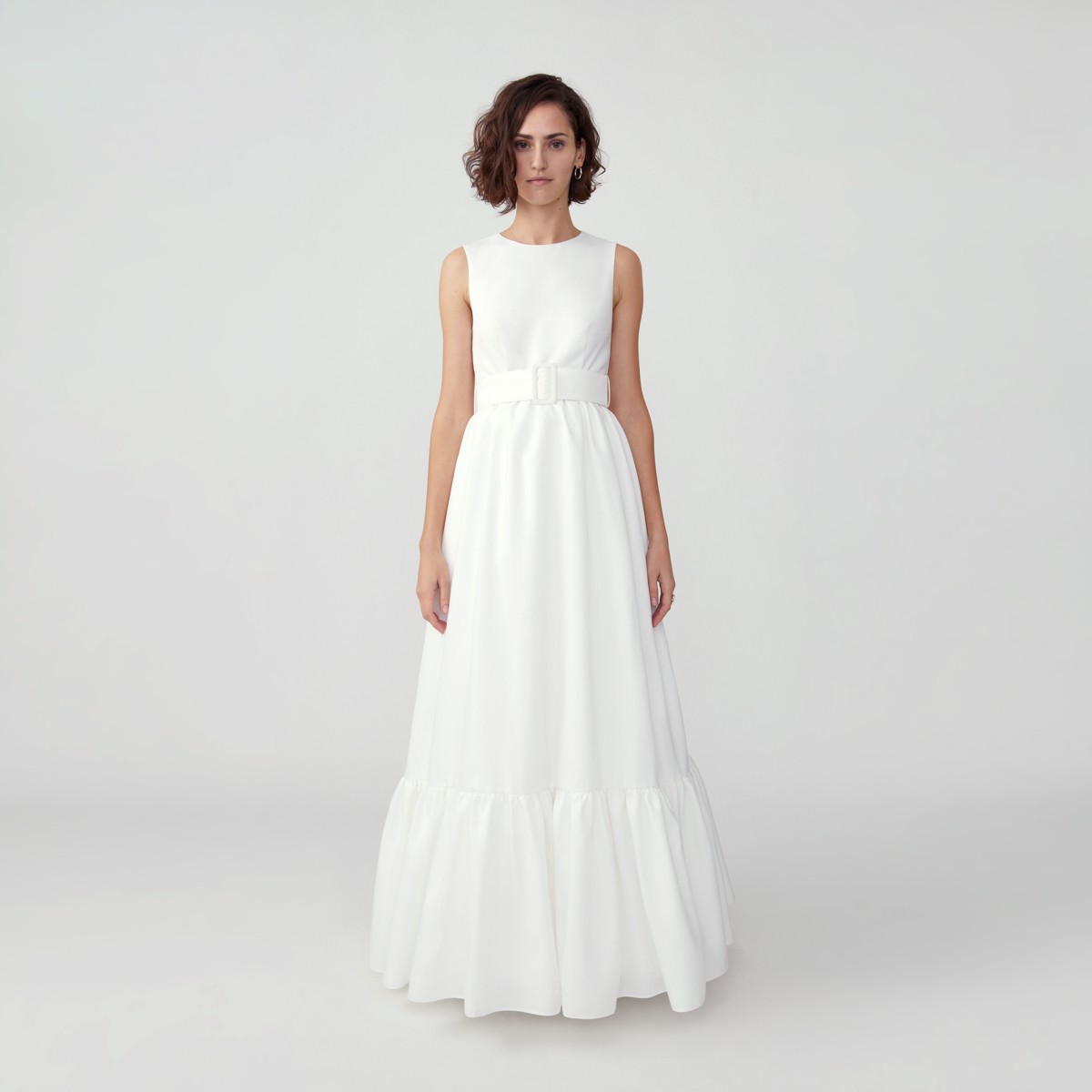 brunette woman wearing a sleeveless belted white wedding dress