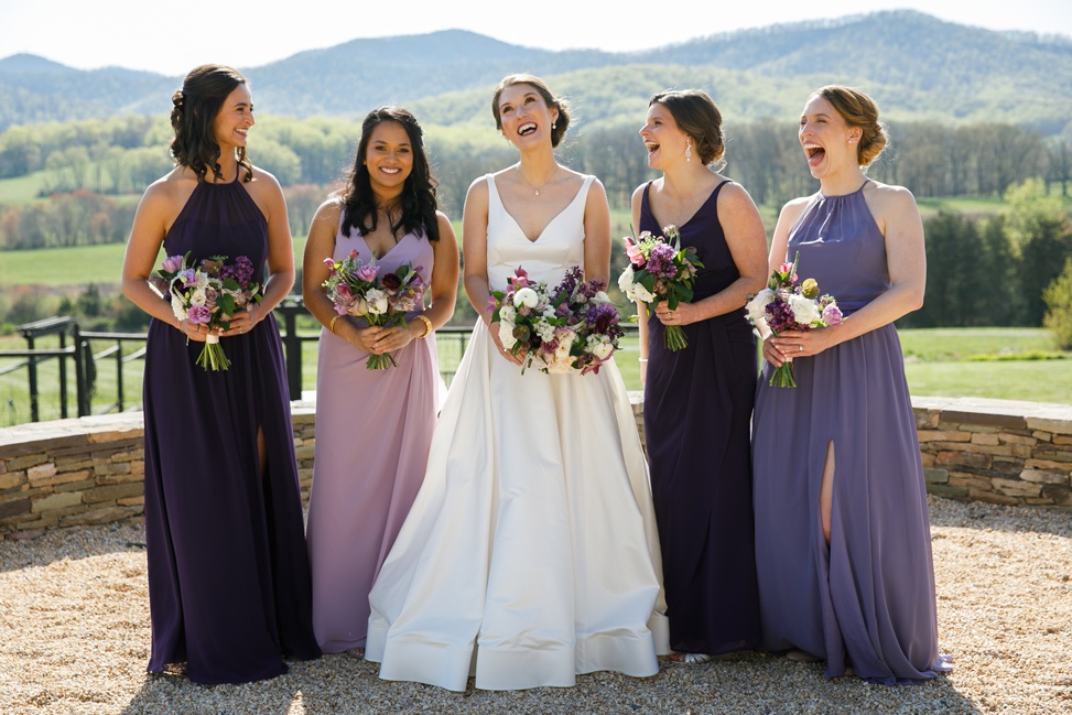 A small bridal party stand together and smile
