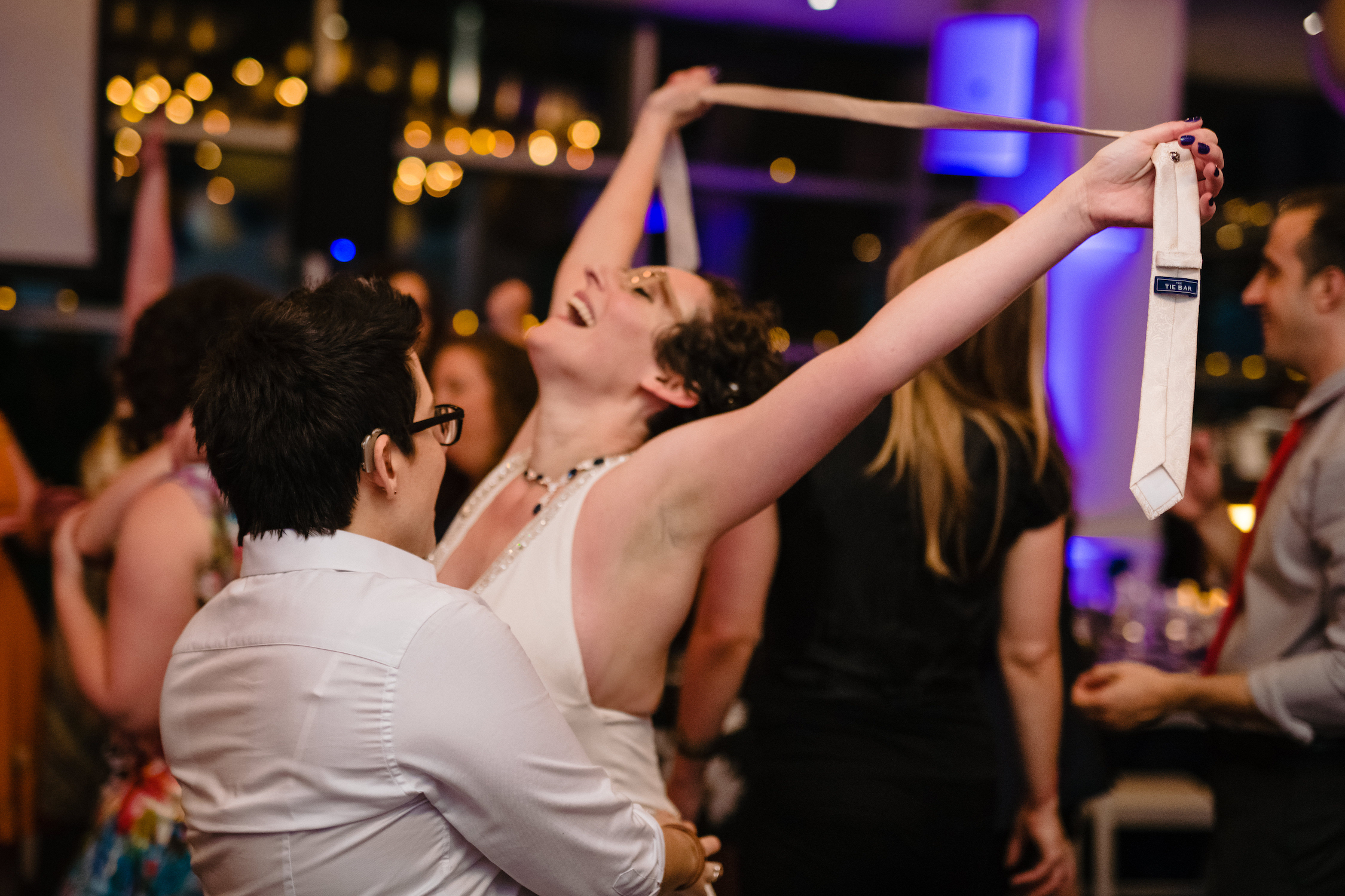 A woman dances with joy during her wedding reception in a photo by Devon Rowland
