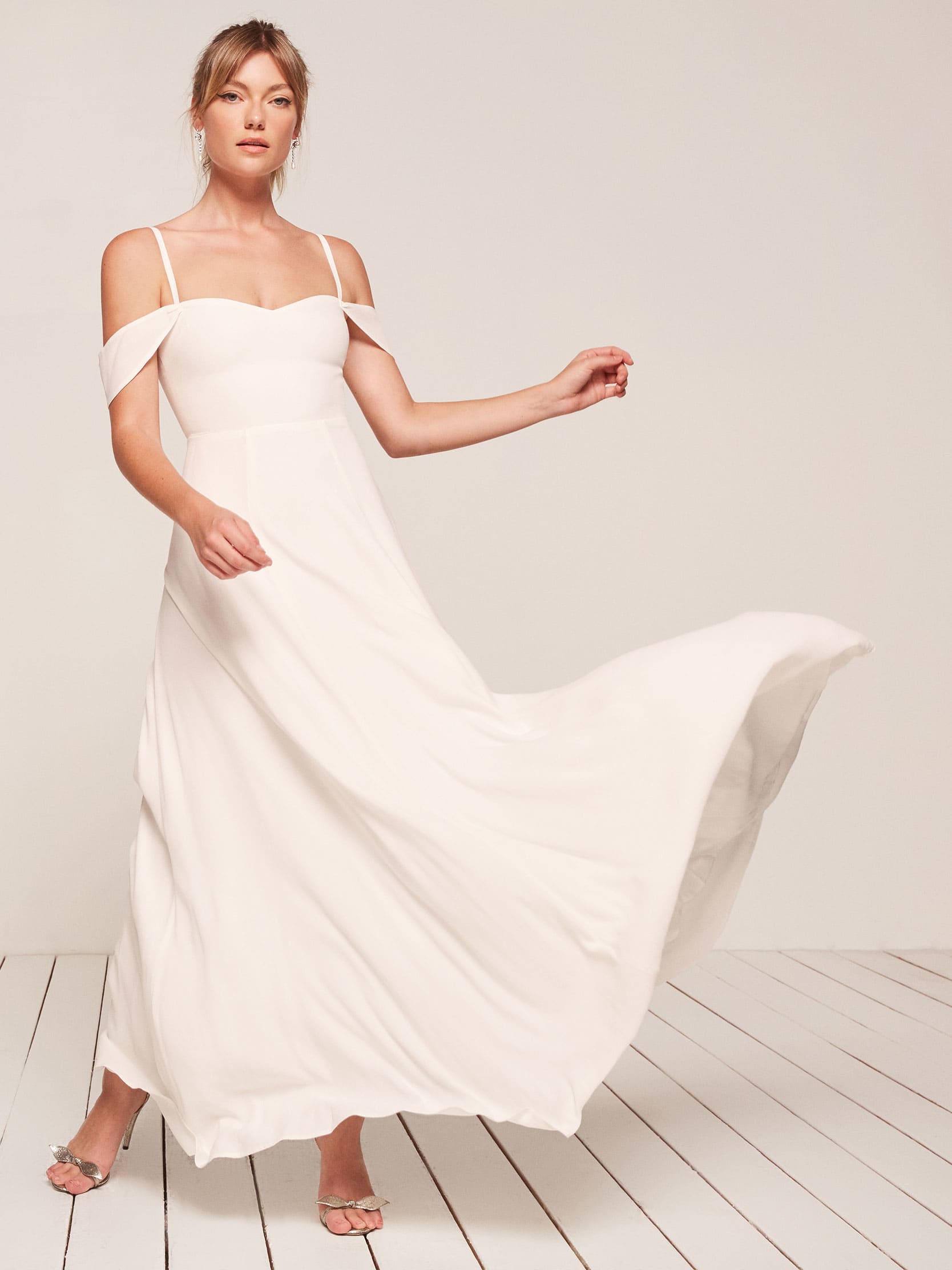 woman wearing a simple off the shoulder wedding dress with thin straps