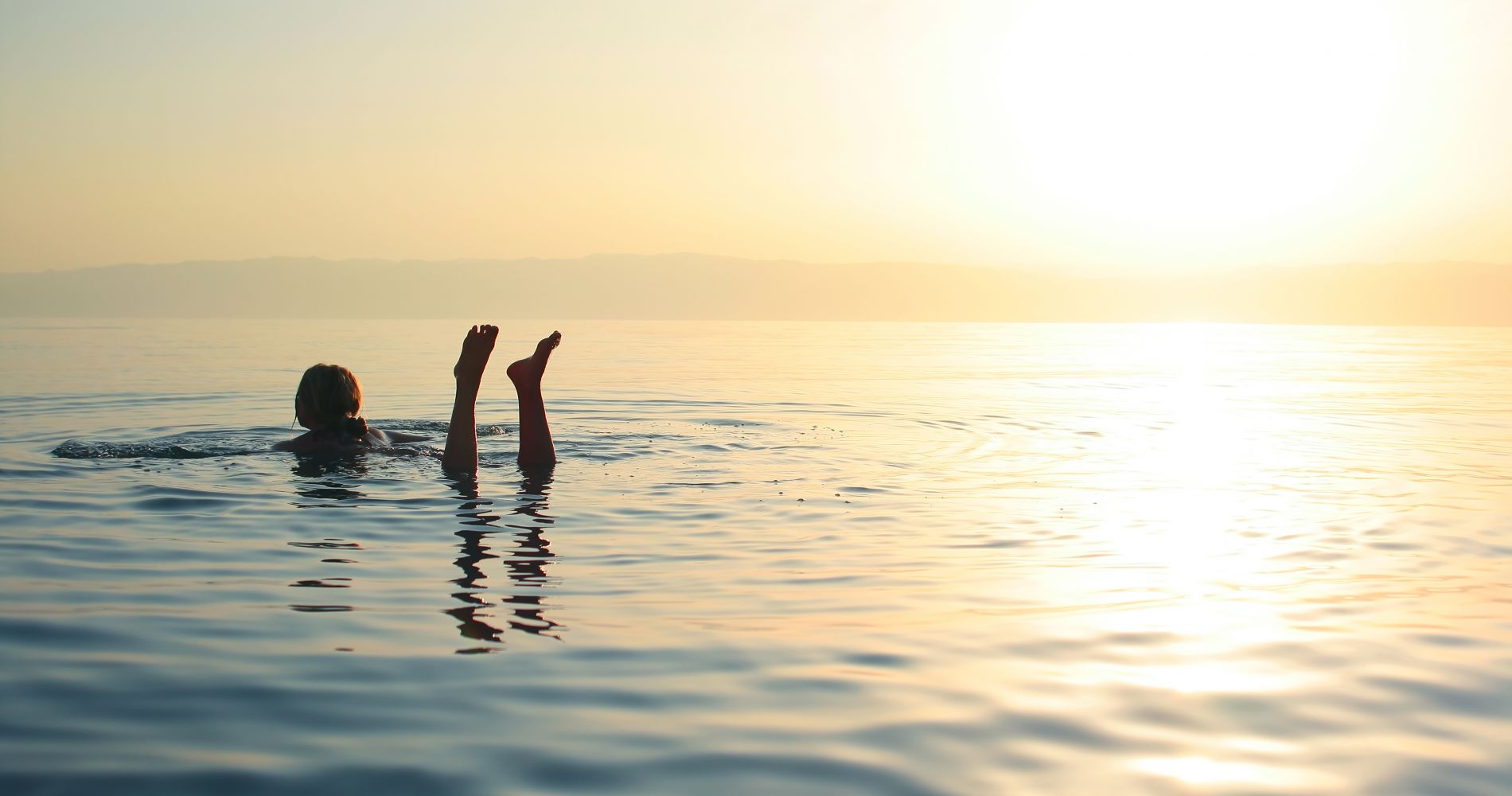 a woman floats in the dead sea as part of a tinggly gift experience