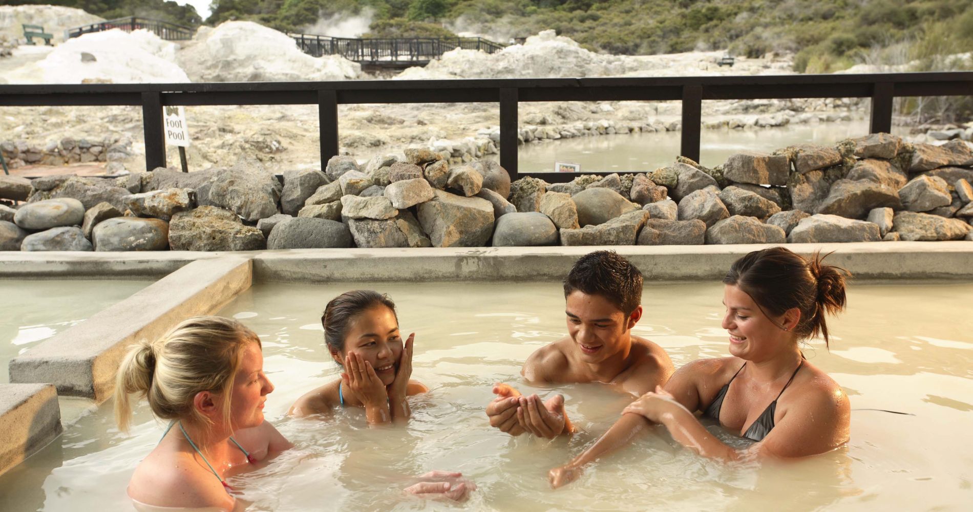two couples sit in a thermal spa in New Zealand as part of a tinggly experience gift