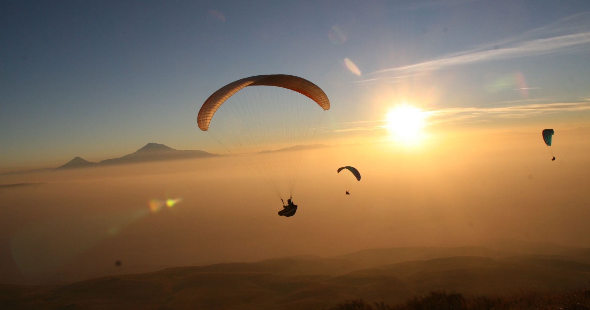 several people paraglide in France as part of a tinggly experience wedding gift
