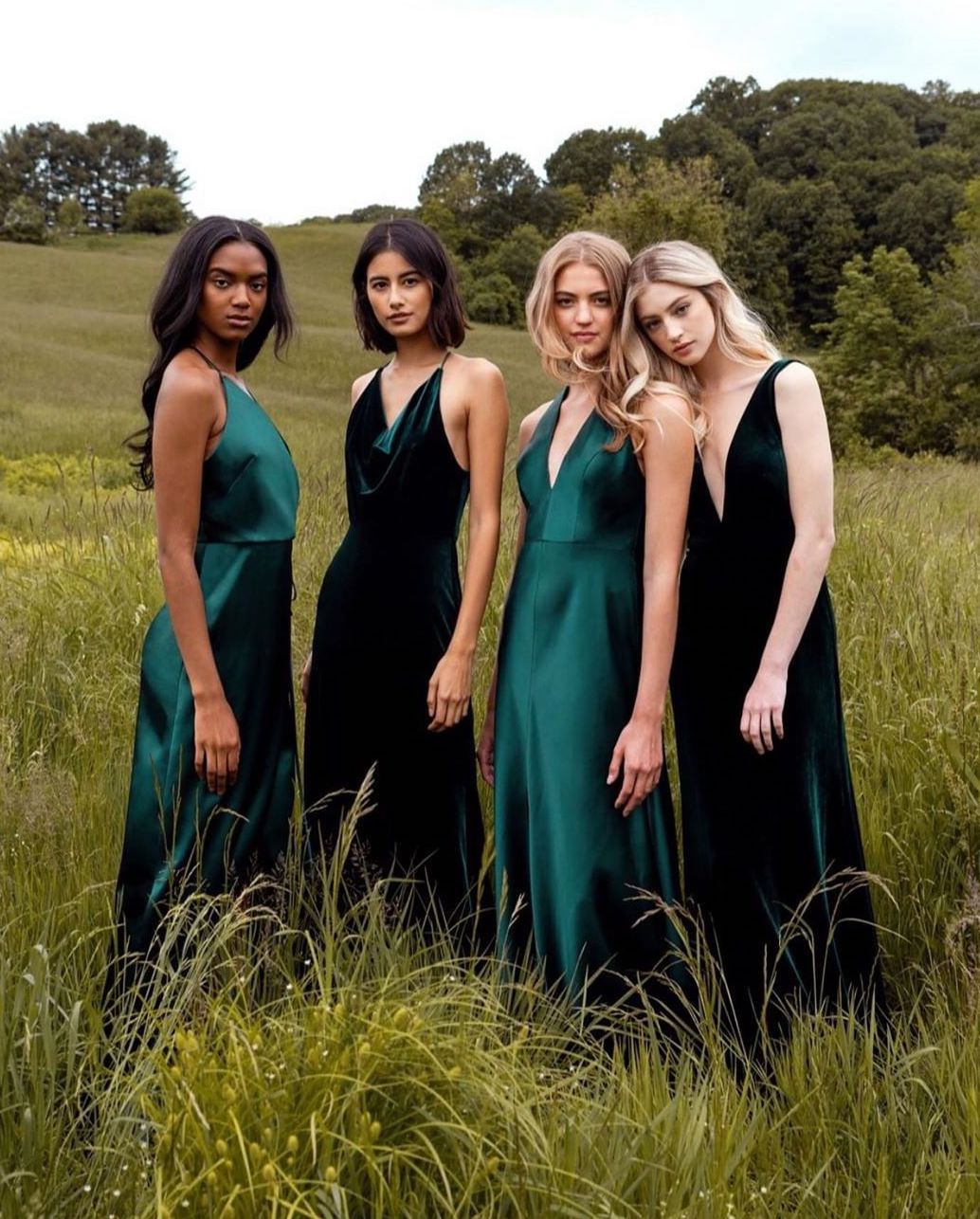 Four models wear dresses of various shades of green.