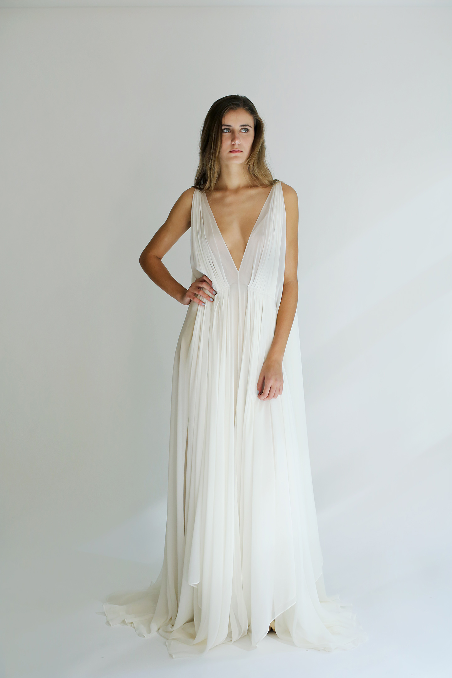 woman wearing a long low cut white formal dress