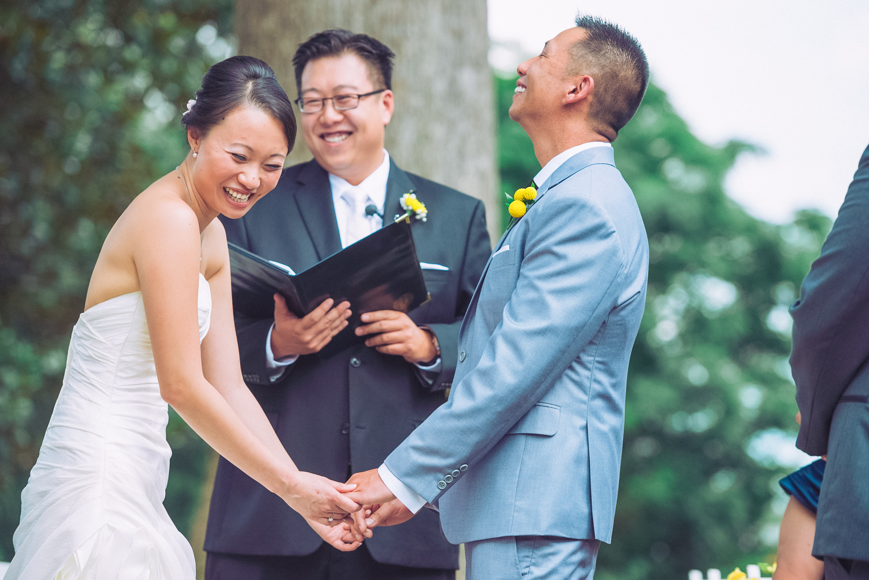 A wedding couple laugh during their ceremony.