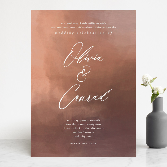 A copper colored wedding invitation