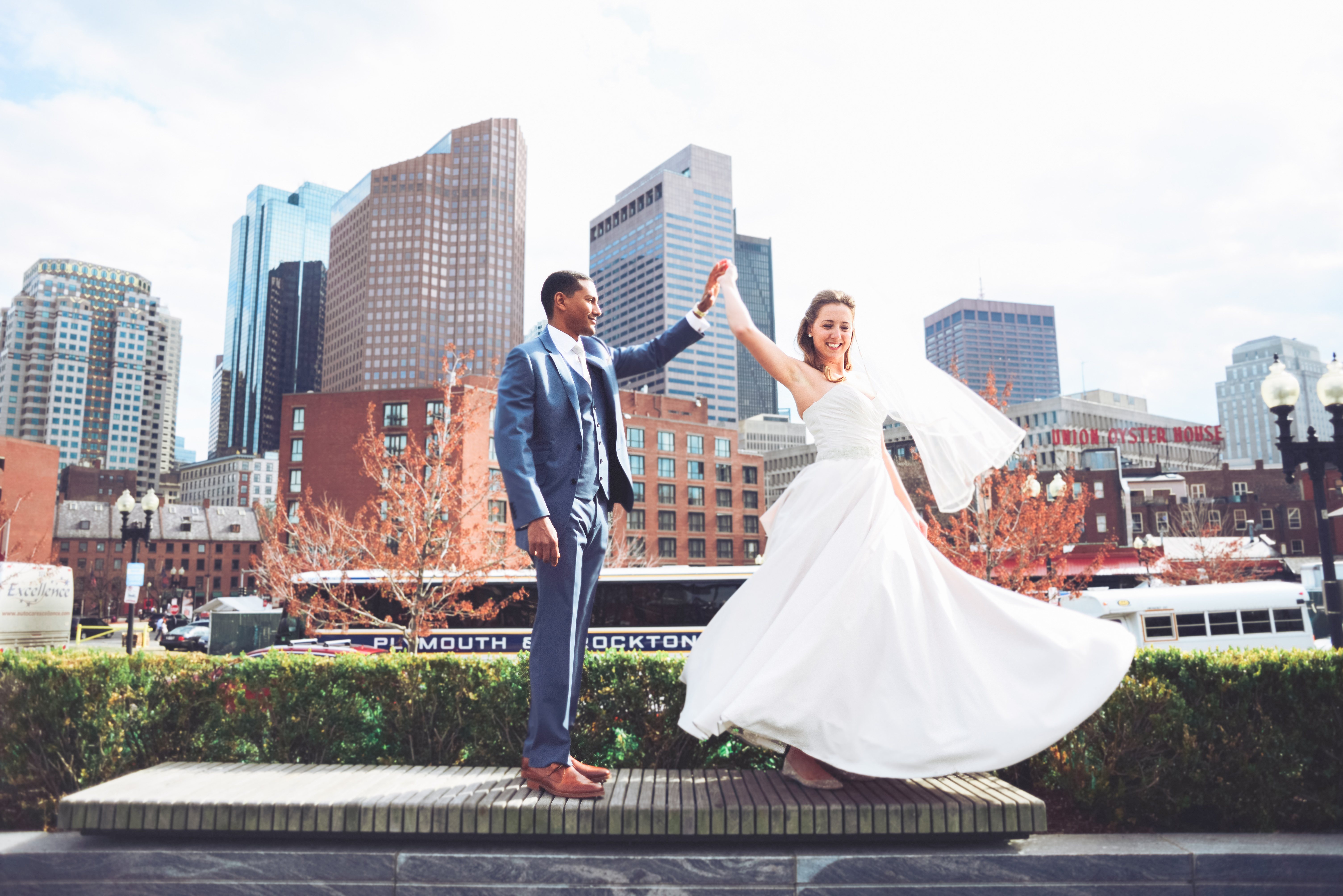 A couple dance with the skyline behind them. Wedding Planning timeline.