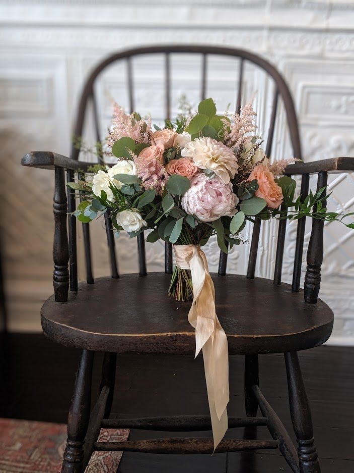 A bridal bouquet on a chair.