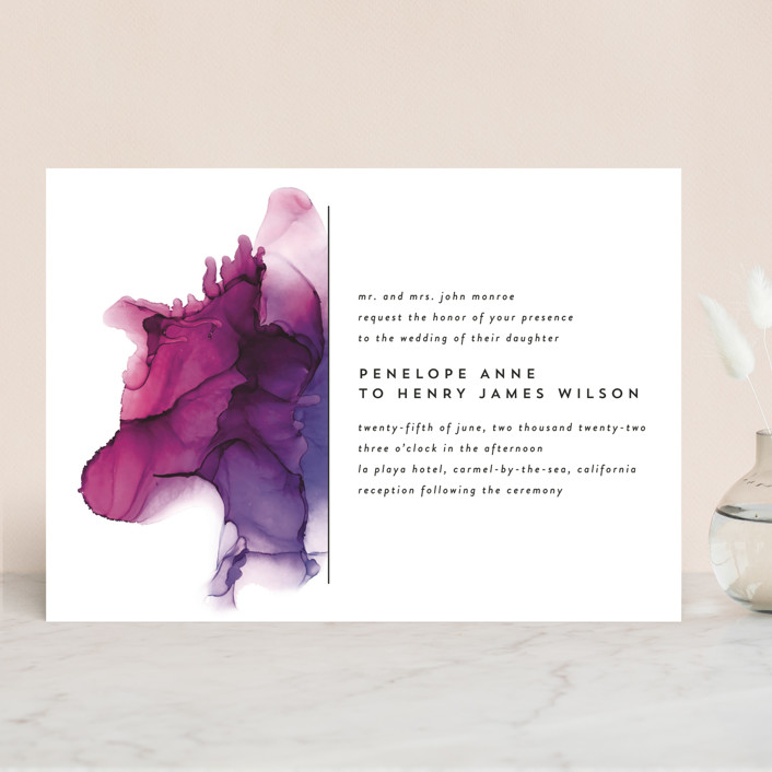 wedding invitation with watercolors on one half in pink and purple, simple black font for wording.
