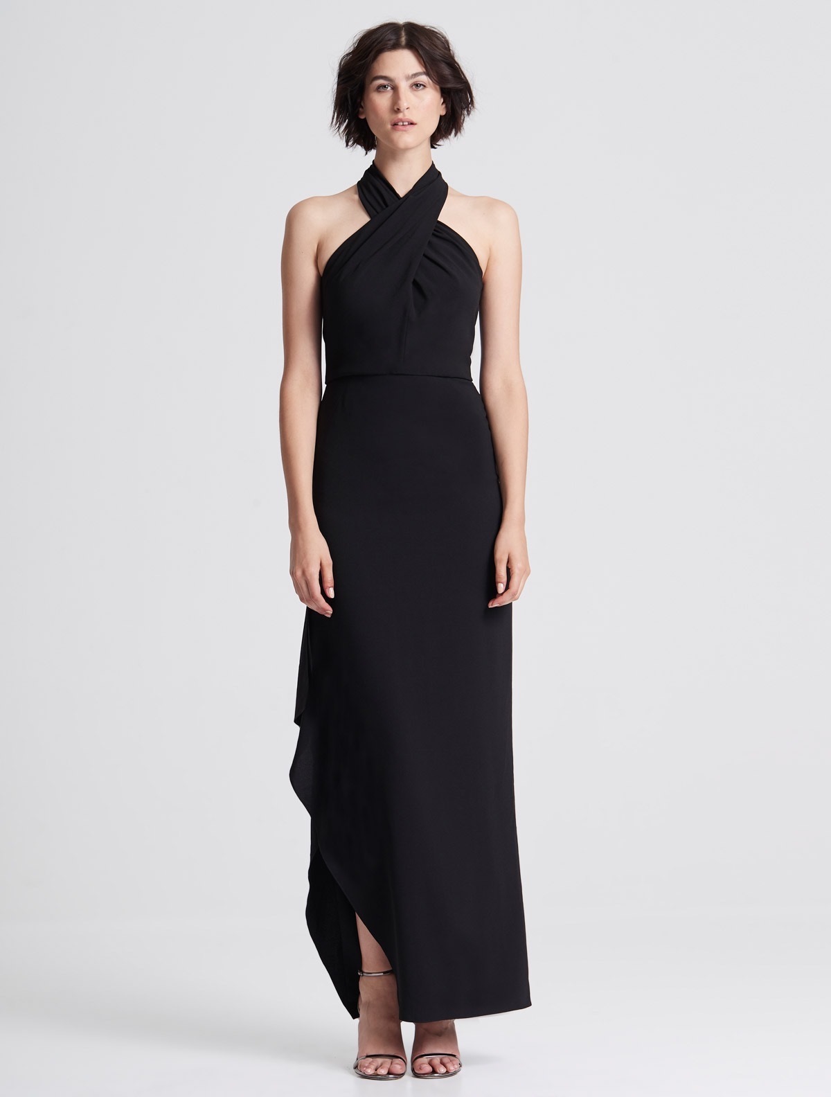 A model wears a stunning cross neck black dress.
