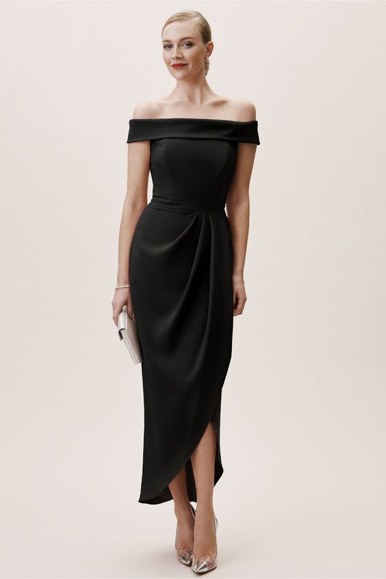 A woman wears a dress Crafted from sleek crepe, this body-hugging dress features a sultry off-the-shoulder neckline and feminine tulip hem. black wedding dresses