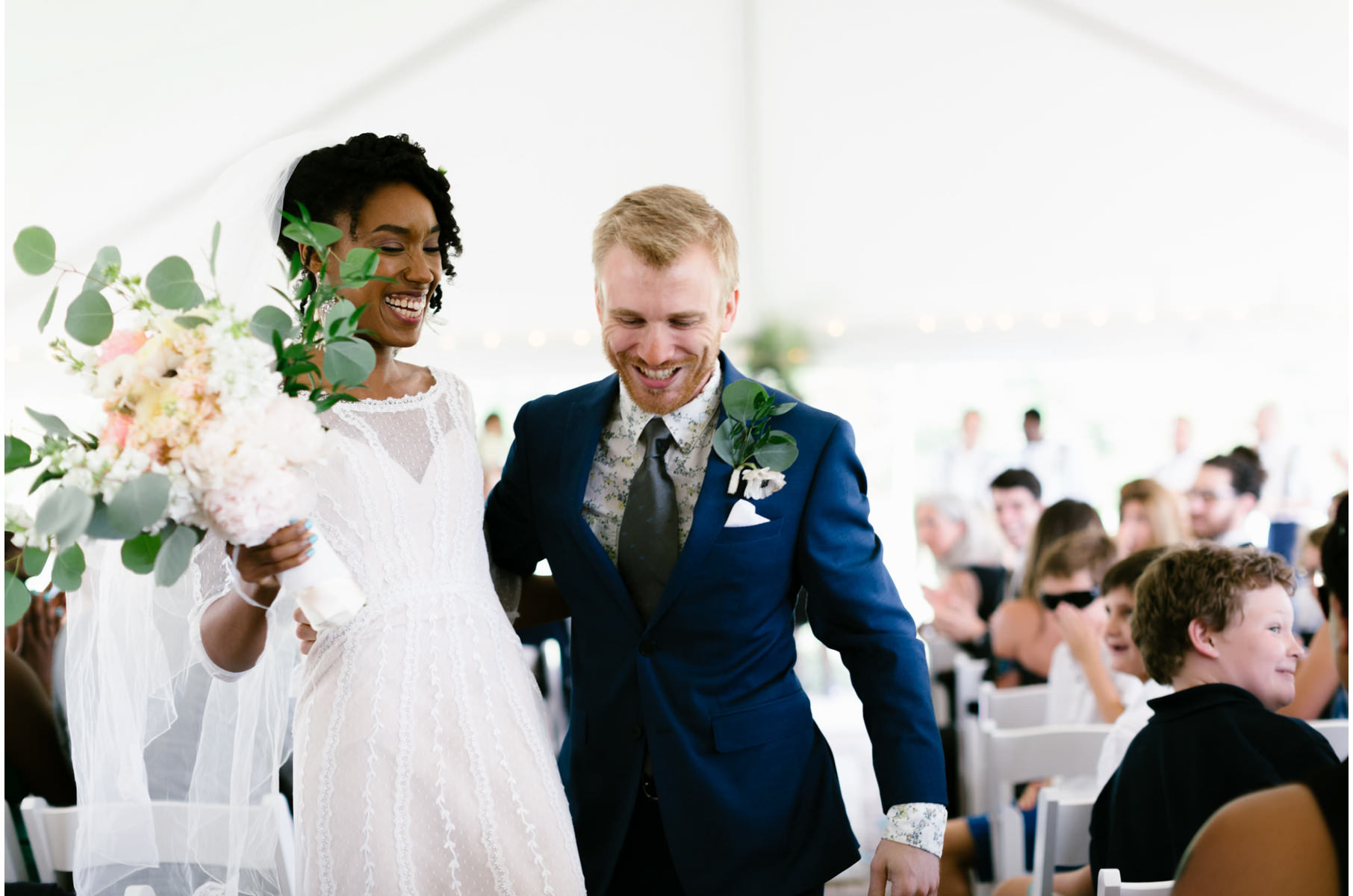 A wedding couple smile during their reception.