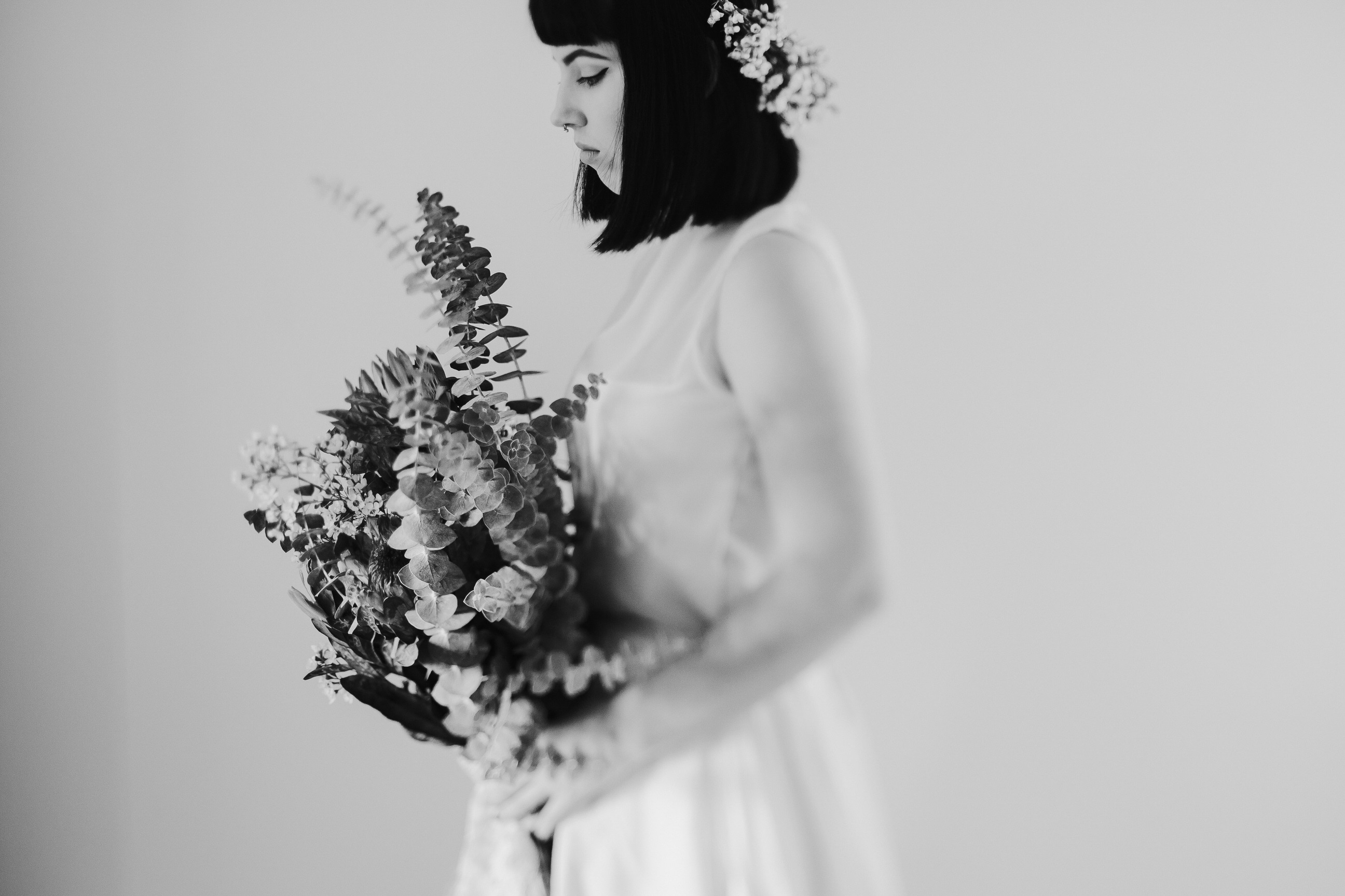 A black and white image of a bride holding her bouquet.