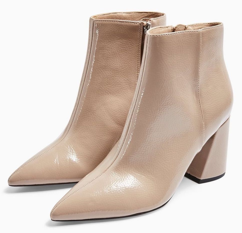 Nude color pointy boots.