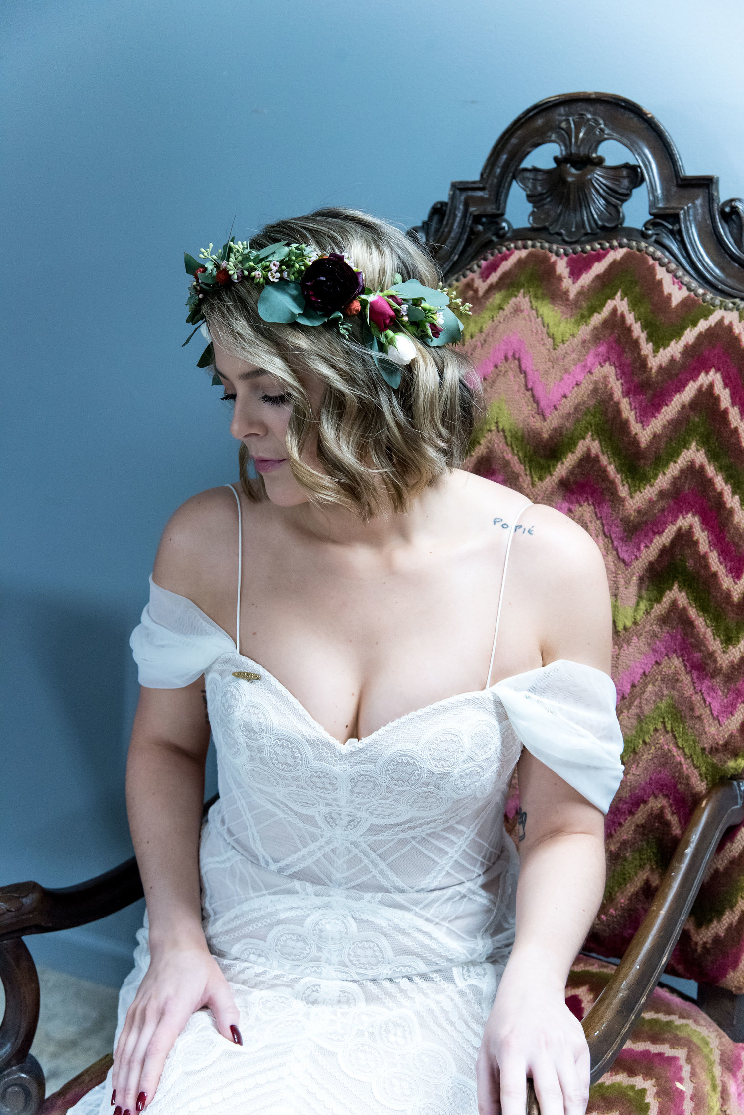A bride sits wearing a flower crown.
