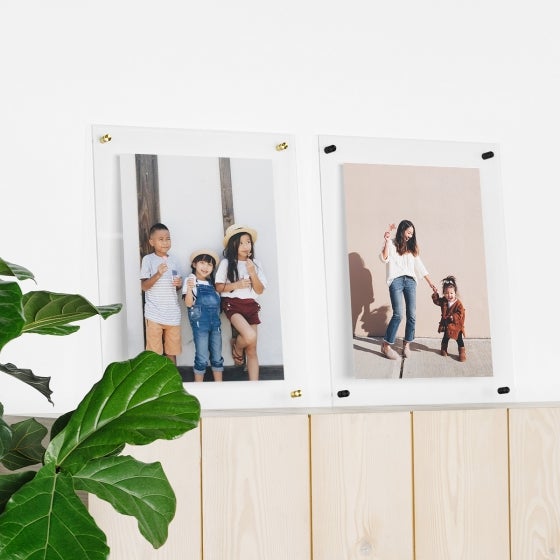 Clear floating frames with photos in them.
