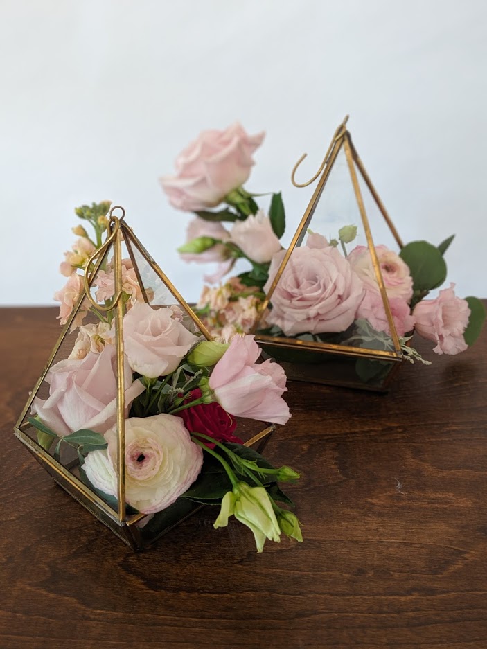 Two triangle shaped floral arrangements.