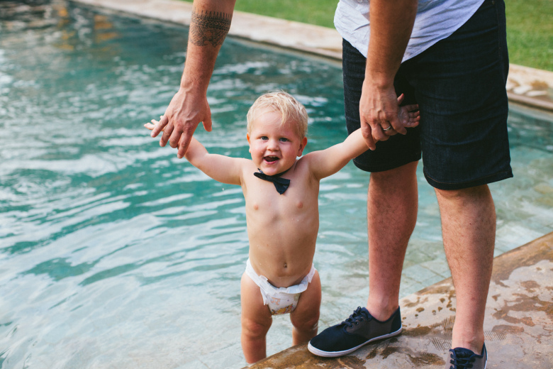 baby in a bow tie at a pool