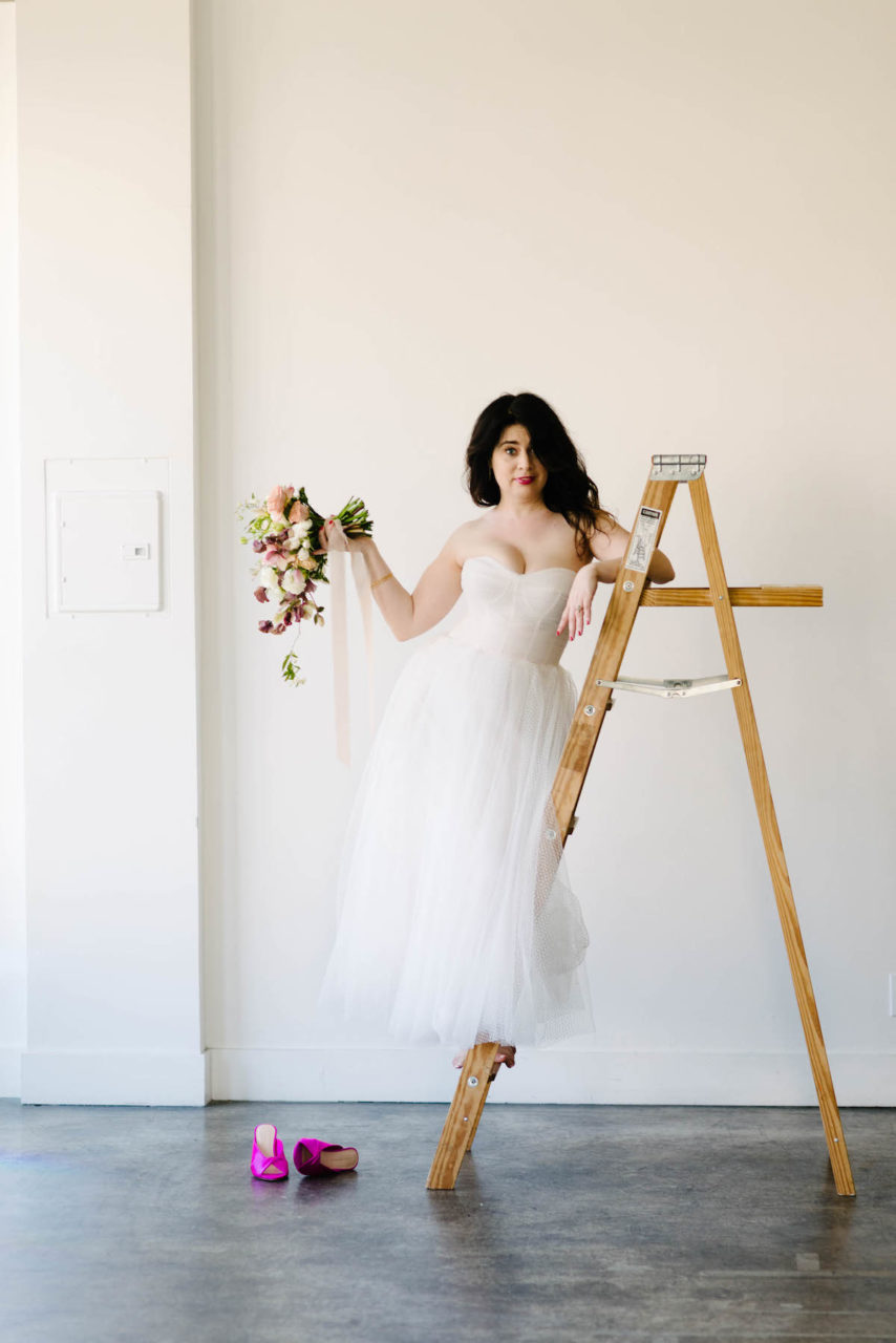 Different wedding dress but still standing on a ladder.