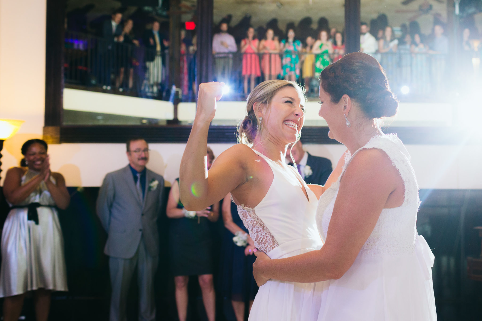 Two women dance during their wedding reception.