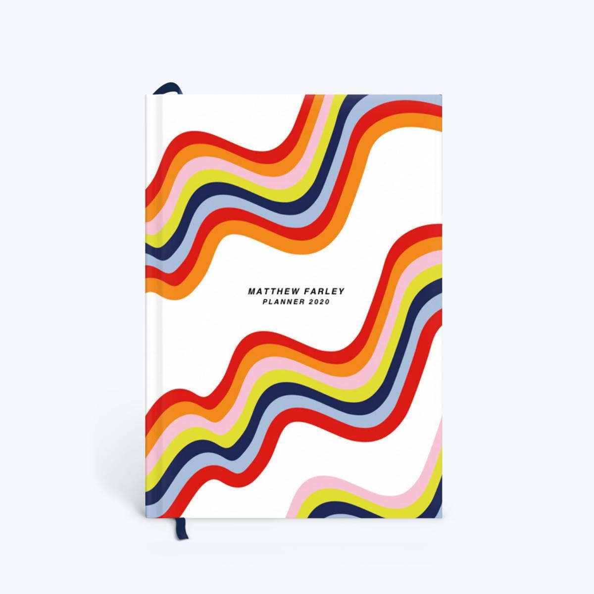 A personalized planner book with a wavy rainbow design on the cover.