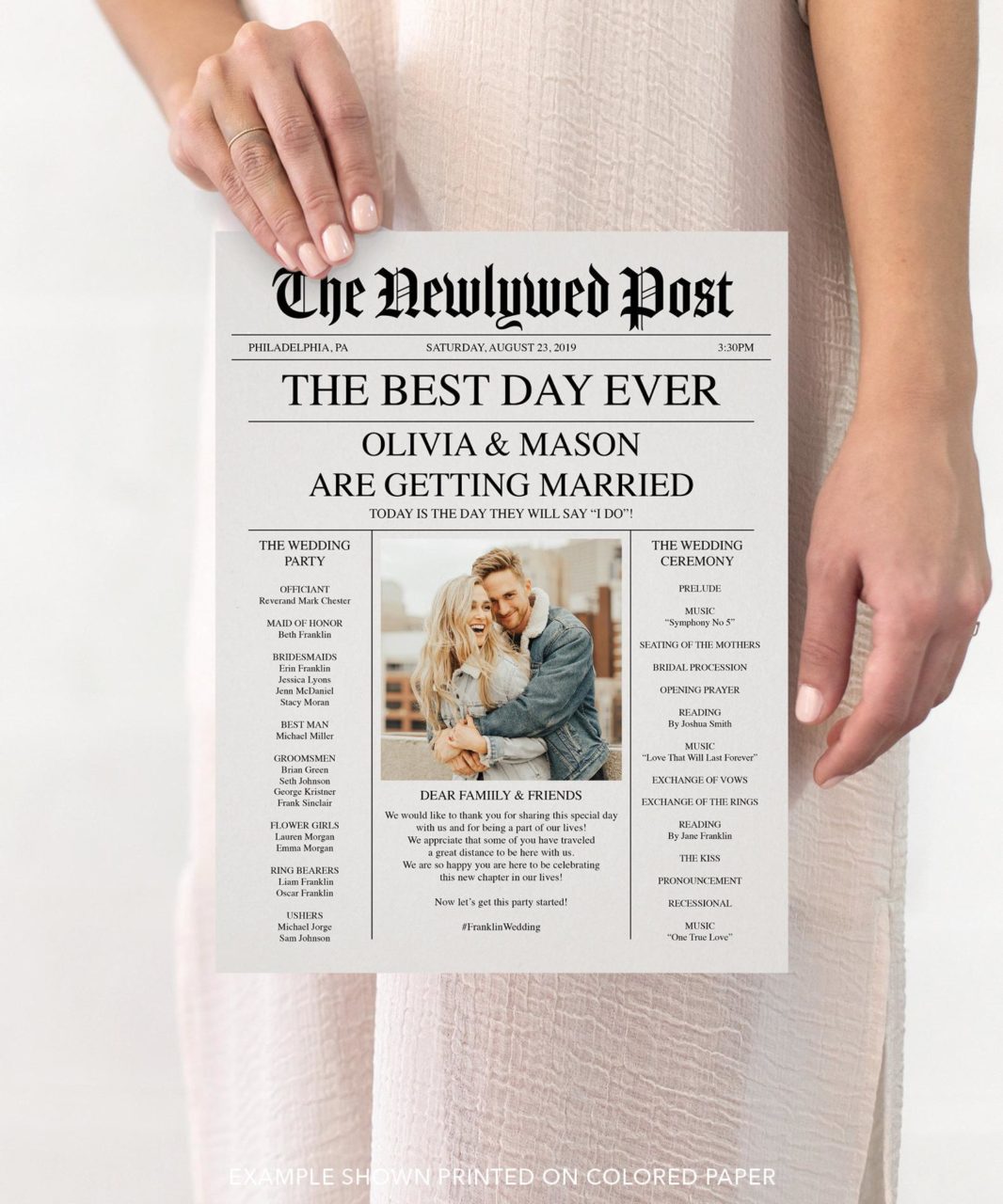 A woman holding a wedding program designed to look like a newspaper