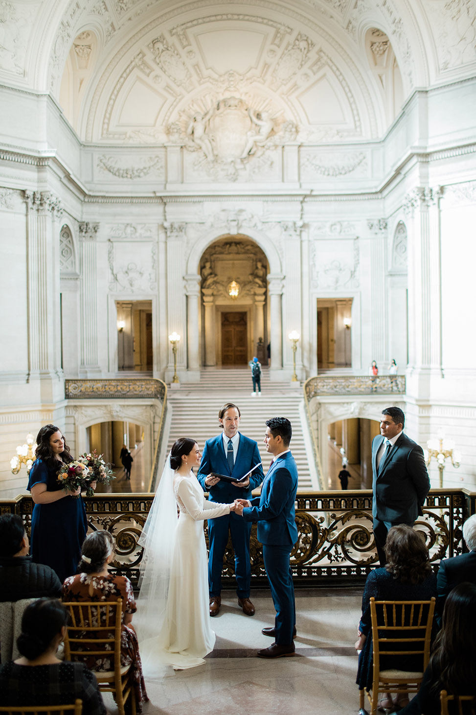 A wedding couple have their ceremony in the middle of City Hall.