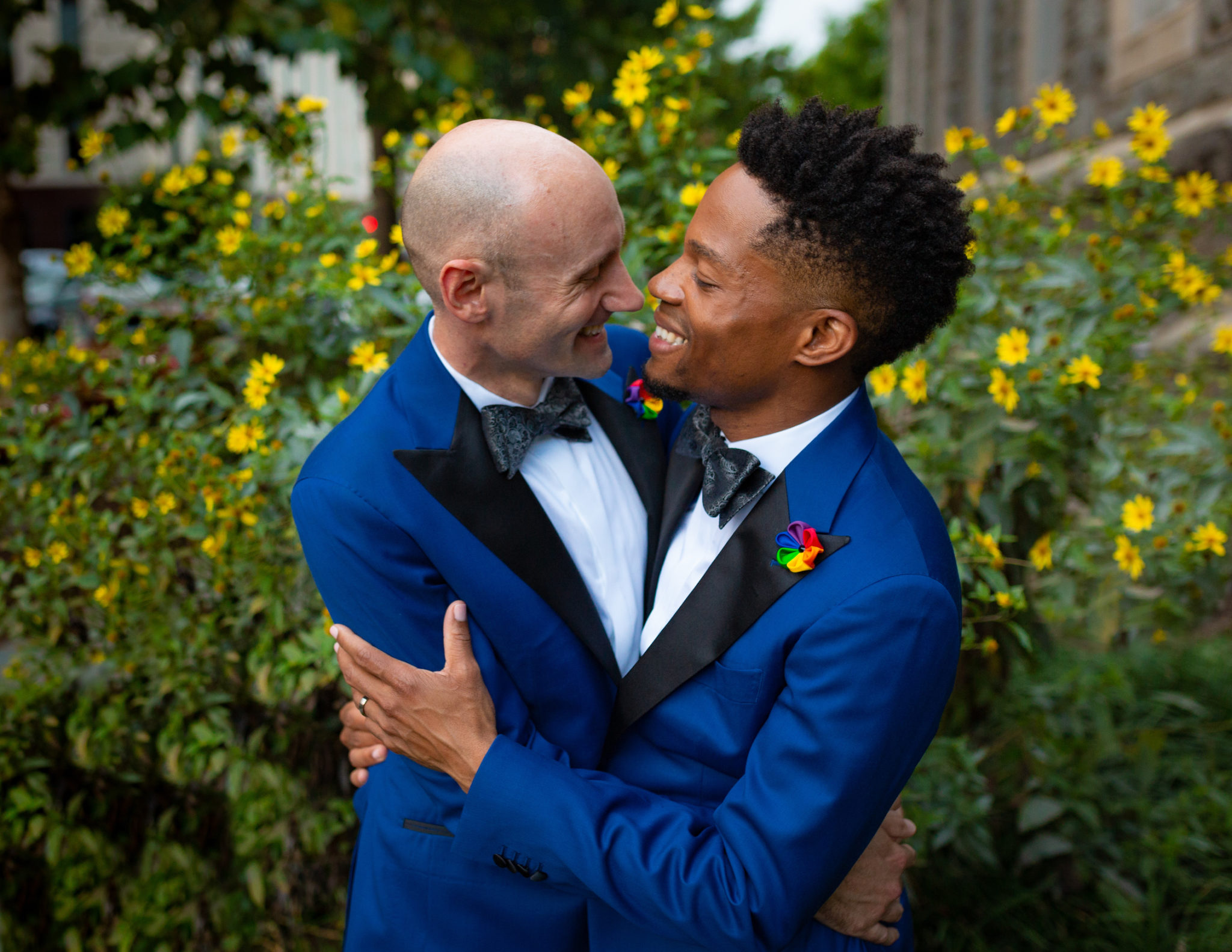 Two men embrace on their wedding day.