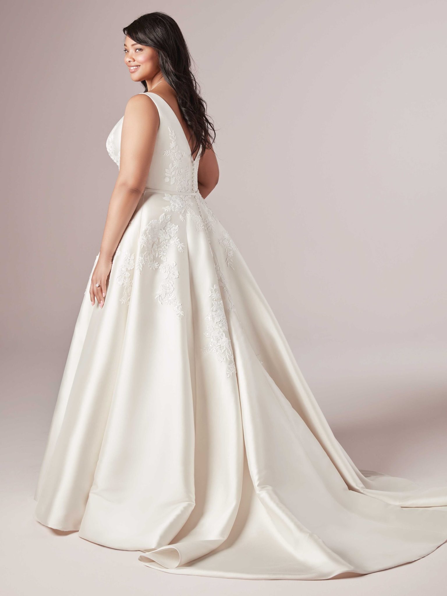 A woman wears the Valerie Lynette by Maggie Sottero