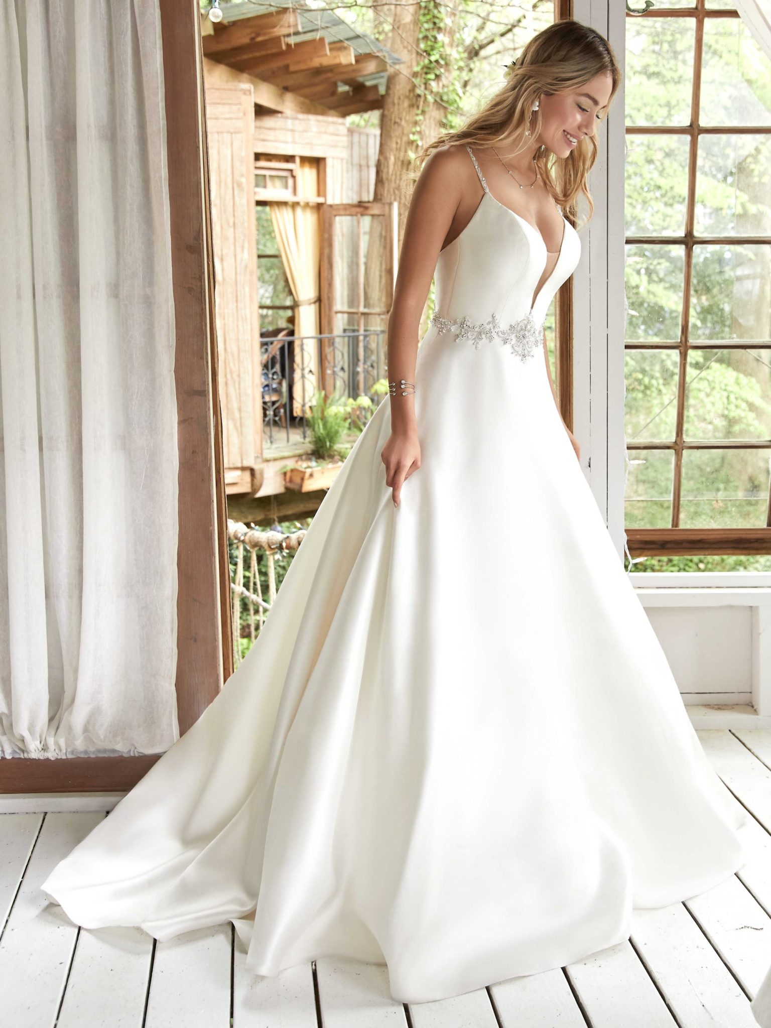 A woman wears Yara by Maggie Sottero
