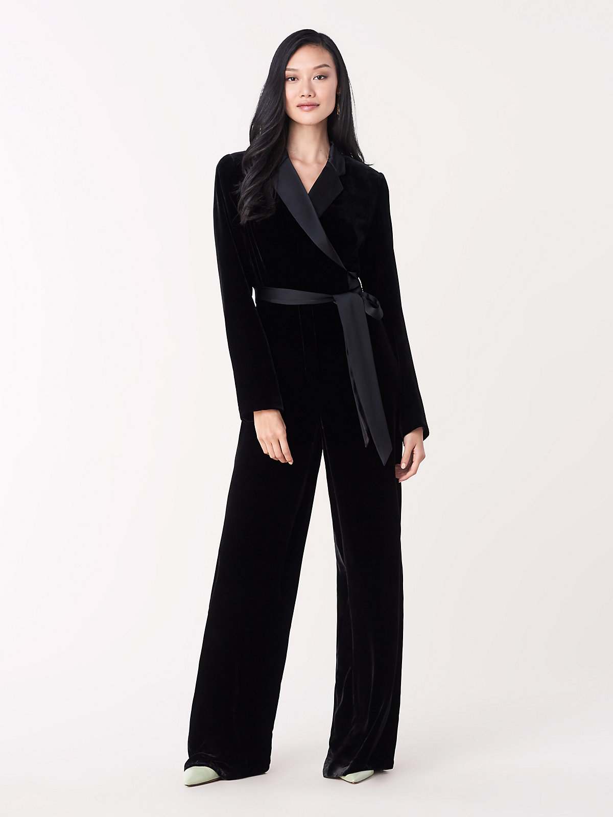 This velvet wedding jumpsuit has a wrap top adorned with a notched lapel and falls into a flattering wide-leg pant.