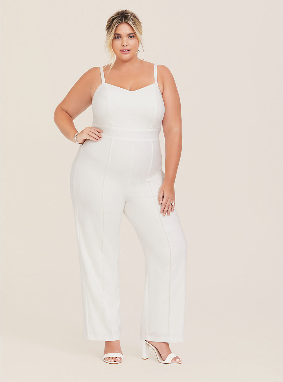 This flattering wedding jumpsuit lends an update to a classic special occasion look with front pintuck accents and cami straps.