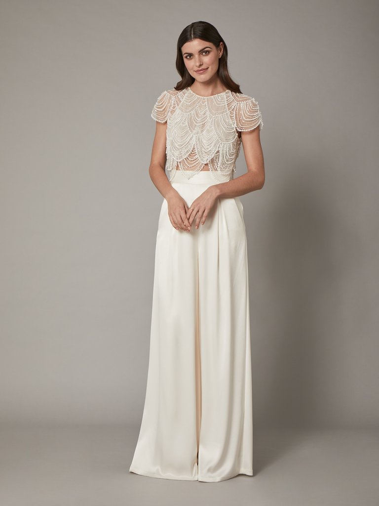 A bride wears wedding separates with a flapper inspired top.