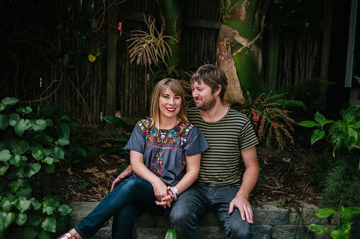 Portrait photo of a couple sitting together in a garden.