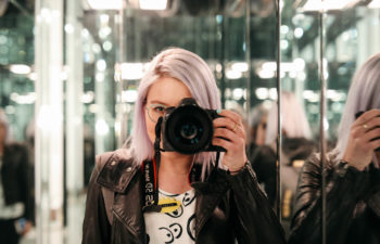 Photographer taking a photo in a mirror