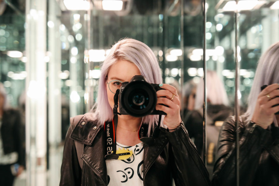 Photographer taking a photo in a mirror