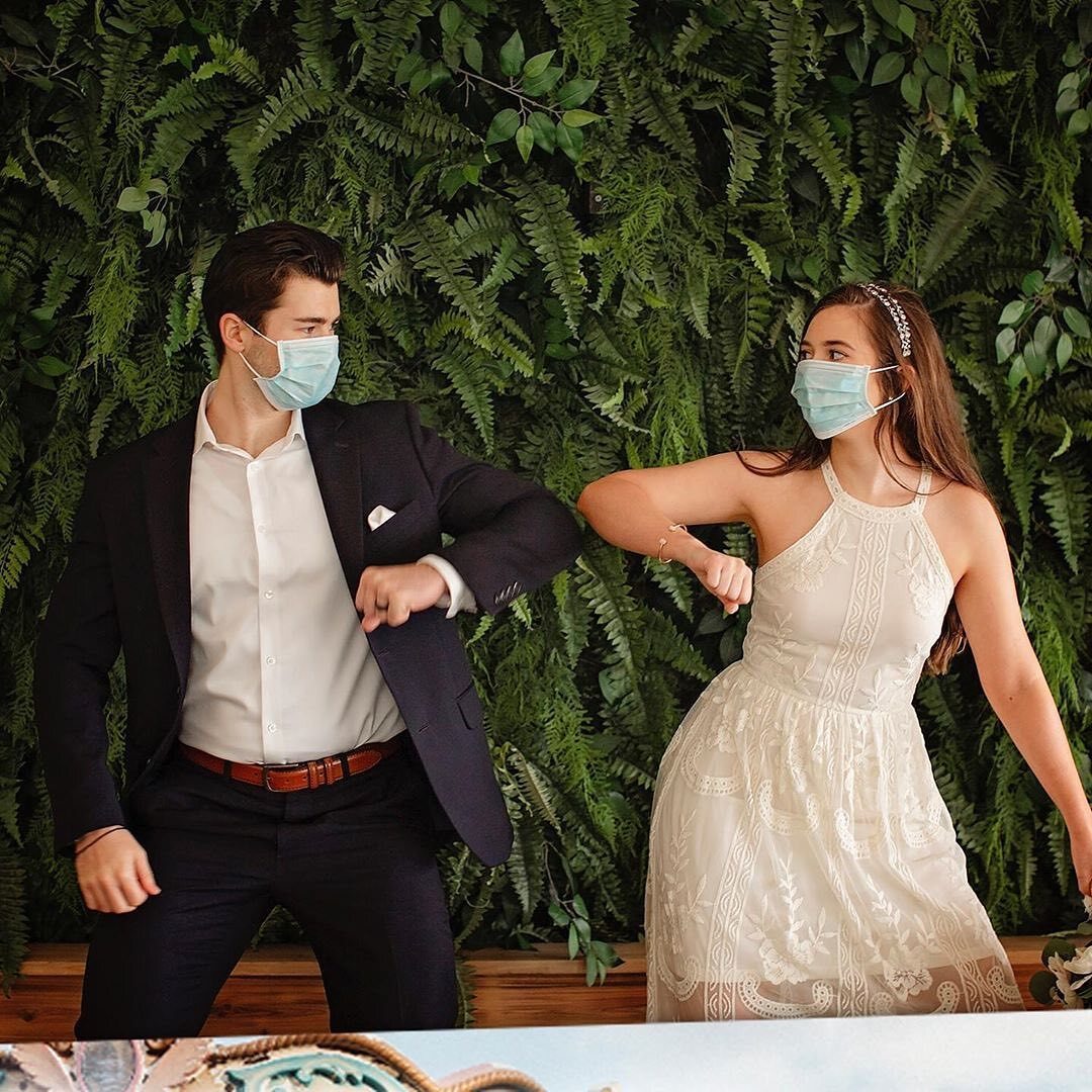 Pandemic wedding couple elbow bumping wearing masks
