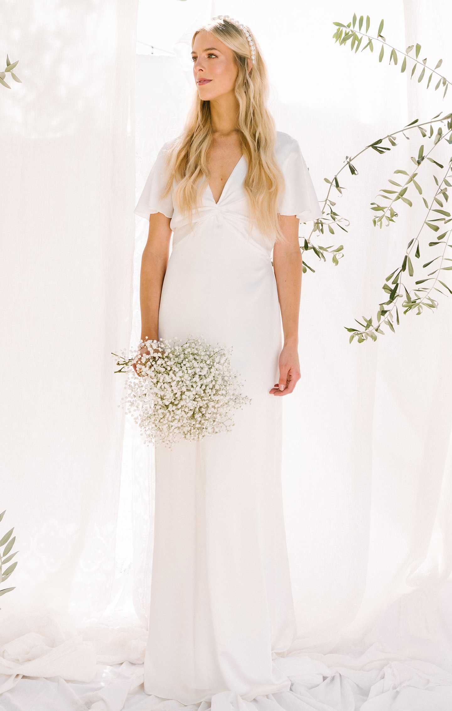 Woman with light hair in off the rack white simple wedding dress