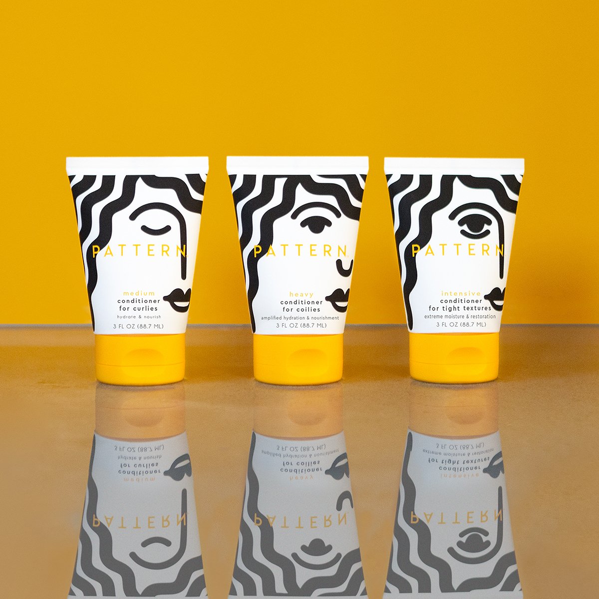 3 bottles of Pattern hair products on a yellow background