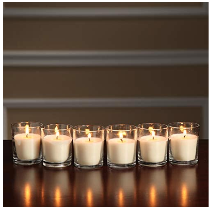 Six white votive candles lit up