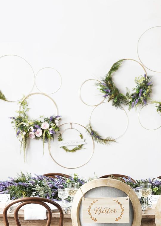 gold craft hoops with flowers artfully arranged on a white wall