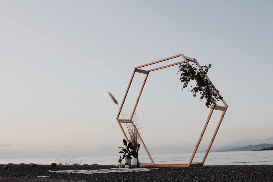 hexagon wedding arch with minimal florals at the waterfront