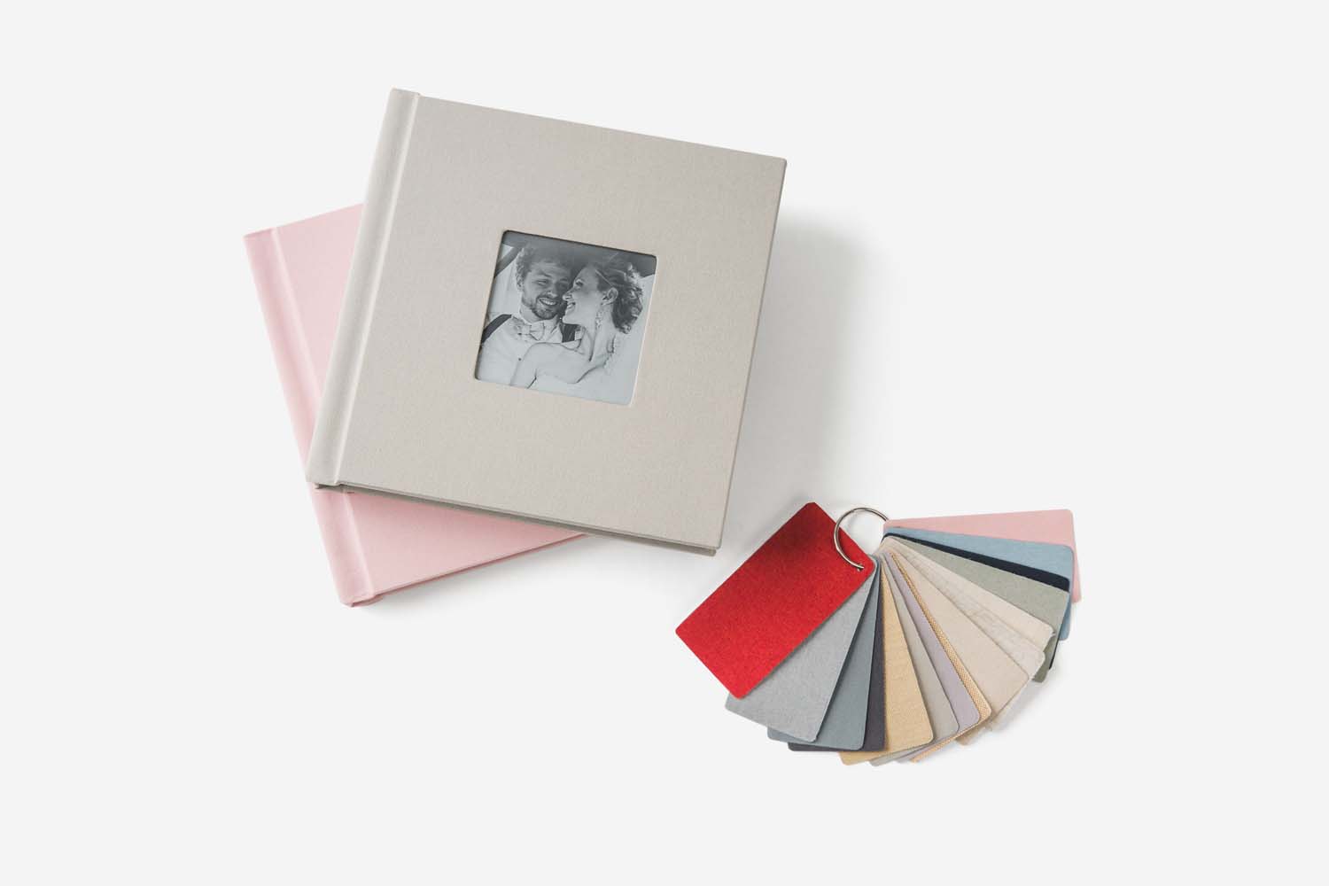 Two Albums Remembered linen wedding albums with a photo inset into the cover shown with a ring of swatches for color options