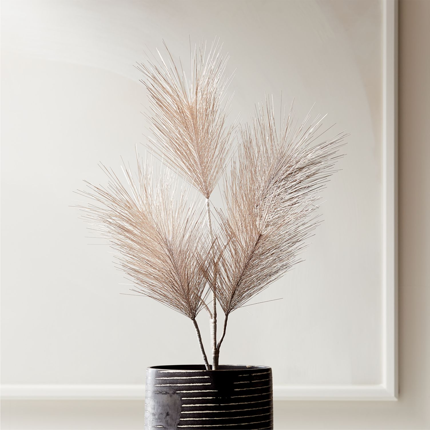 light pink stems in a black vase
